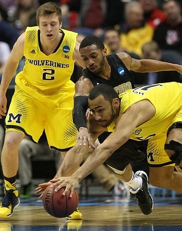 Spike Albrecht (2) and Jon Horford (15)