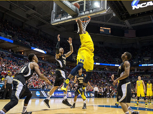 Derrick Walton Jr. (10), Jon Horford (15), and Caris LeVert (23)