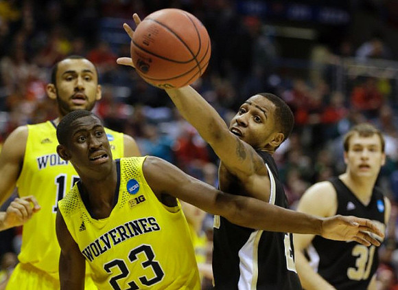 Jon Horford (15) and Caris LeVert (23)