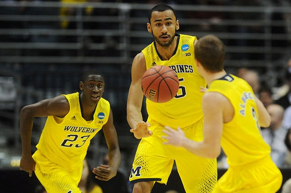 Caris LeVert (23), Jon Horford (15), and Spike Albrecht (2)