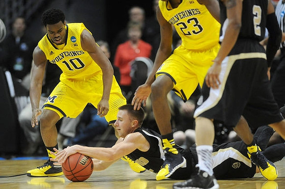 Derrick Walton Jr. (10) and Caris LeVert (23)