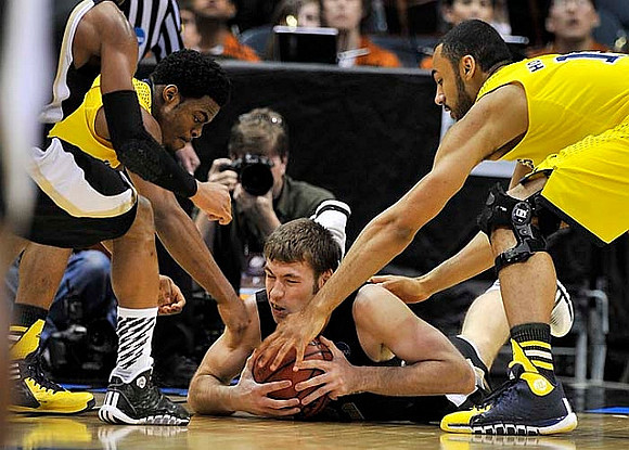 Derrick Walton Jr. (10) and Jon Horford (15)