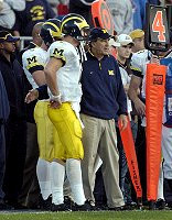 Lloyd Carr, Chad Henne (7), and Clayton Richards (10)