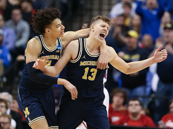 D.J. Wilson (5) and Moritz Wagner (13)