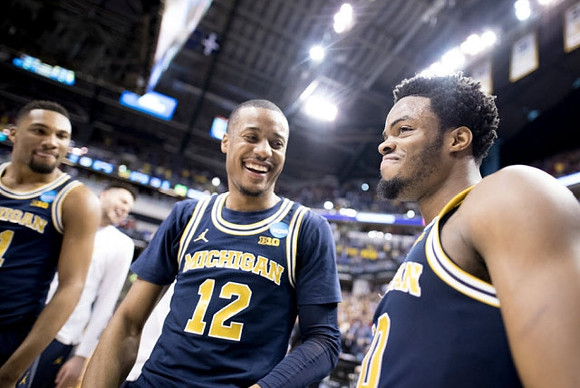 Zak Irvin (21), Muhammad-Ali Abdur-Rahkman (12), and Derrick Walton Jr. (10)