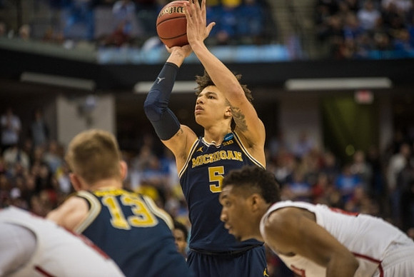 Moritz Wagner (13) and D.J. Wilson (5)