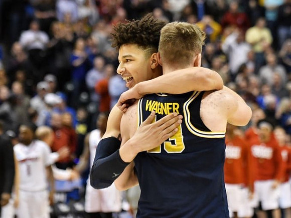 D.J. Wilson (5) and Moritz Wagner (13)
