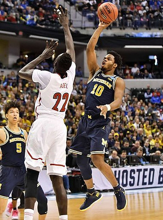 D.J. Wilson (5) and Derrick Walton Jr. (10)