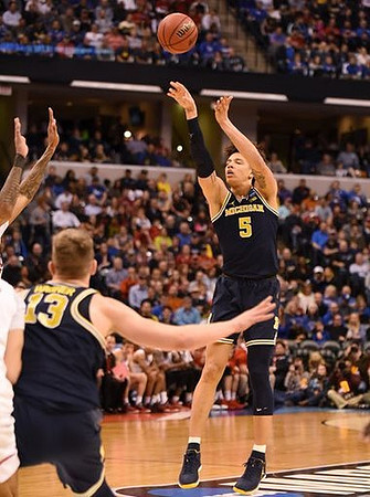 Moritz Wagner (13) and D.J. Wilson (5)