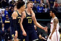 D.J. Wilson (5) and Moritz Wagner (13)