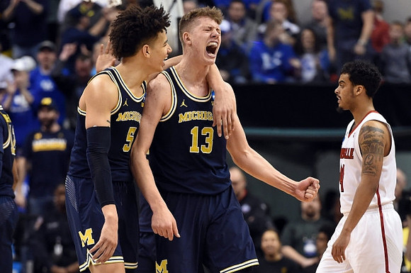 D.J. Wilson (5) and Moritz Wagner (13)