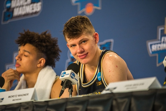 D.J. Wilson (5) and Moritz Wagner (13)