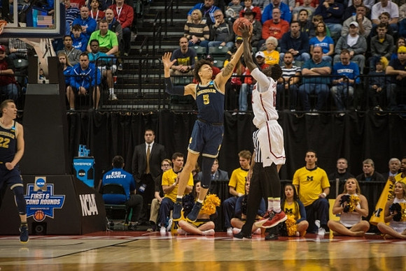 Duncan Robinson (22) and D.J. Wilson (5)