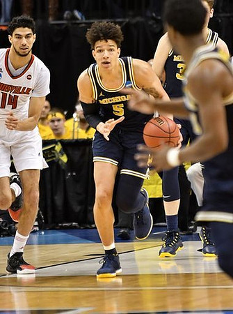 D.J. Wilson (5) and Mark Donnal (34)