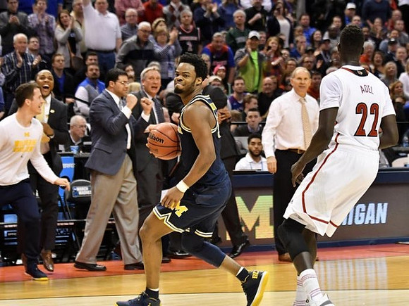 Andrew Dakich (11), Derrick Walton Jr. (10), and John Beilein