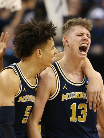 D.J. Wilson (5) and Moritz Wagner (13)