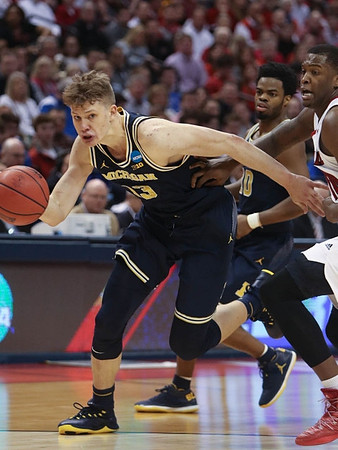 Moritz Wagner (13) and Derrick Walton Jr. (10)