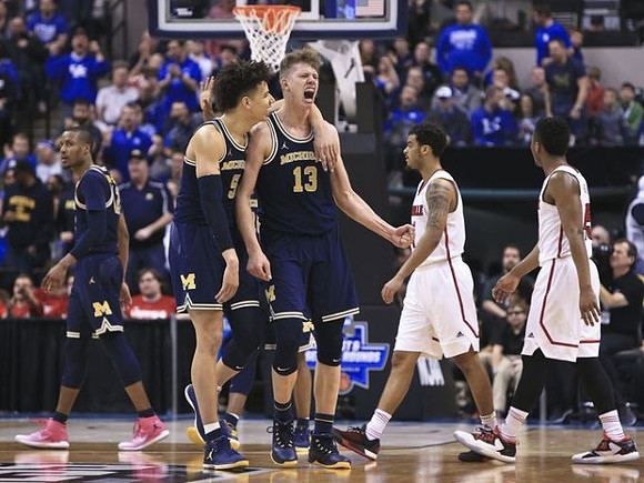 Muhammad-Ali Abdur-Rahkman (12), D.J. Wilson (5), and Moritz Wagner (13)