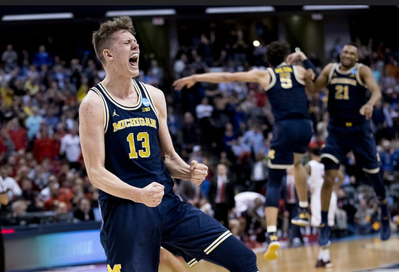 Moritz Wagner (13), D.J. Wilson (5), and Zak Irvin (21)