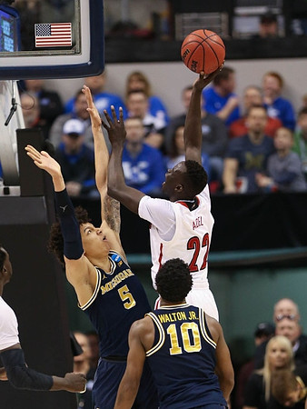 D.J. Wilson (5) and Derrick Walton Jr. (10)