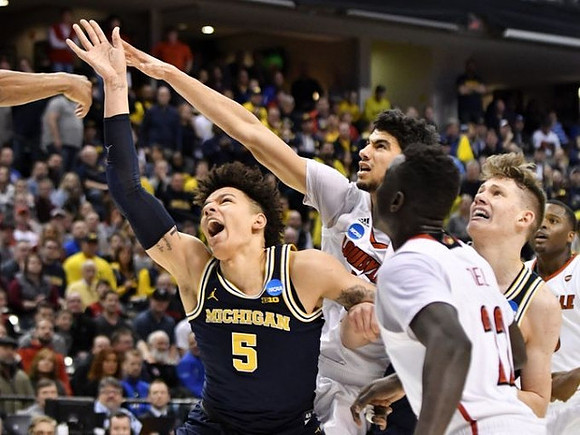 D.J. Wilson (5) and Moritz Wagner (13)
