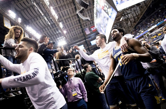 Brent Hibbitts (0), Derrick Walton Jr. (10), and Sean Lonergan (20)