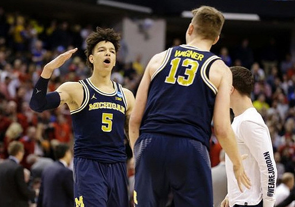 D.J. Wilson (5) and Moritz Wagner (13)