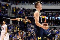 Moritz Wagner (13), D.J. Wilson (5), and Zak Irvin (21)