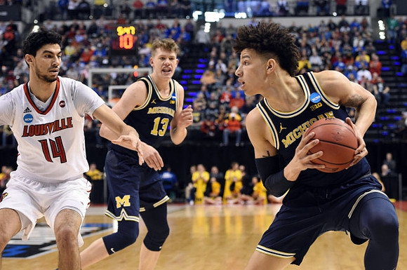Moritz Wagner (13) and D.J. Wilson (5)