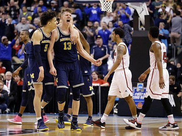 D.J. Wilson (5) and Moritz Wagner (13)