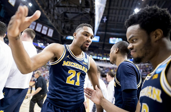 Zak Irvin (21), Muhammad-Ali Abdur-Rahkman (12), and Derrick Walton Jr. (10)