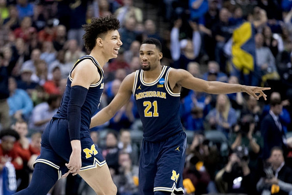 D.J. Wilson (5) and Zak Irvin (21)