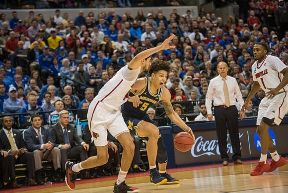 D.J. Wilson (5) and John Beilein