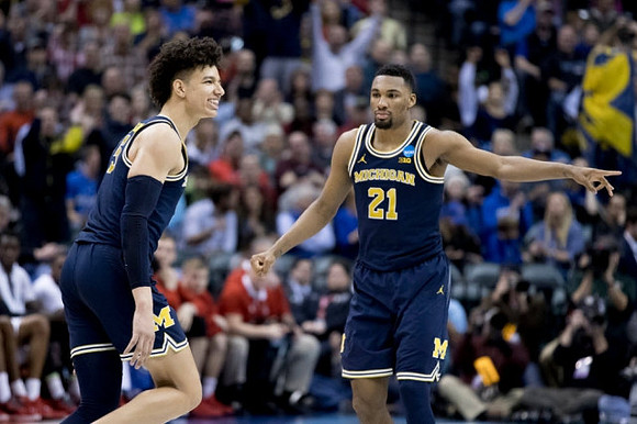 D.J. Wilson (5) and Zak Irvin (21)