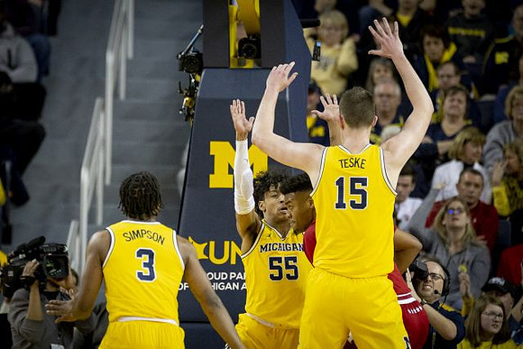 Zavier Simpson (3), Eli Brooks (55), and Jon Teske (15)
