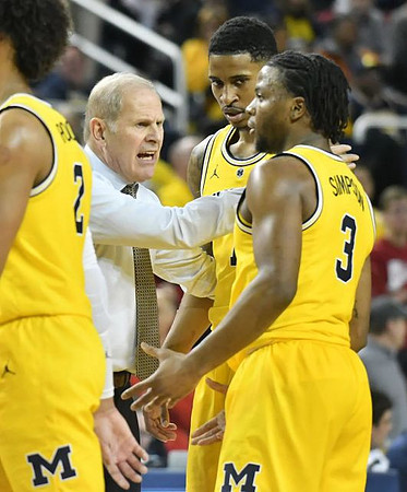Jordan Poole (2), John Beilein, Charles Matthews (1), and Zavier Simpson (3)