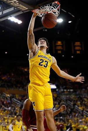 Brandon Johns Jr. (23) and Jordan Poole (2)