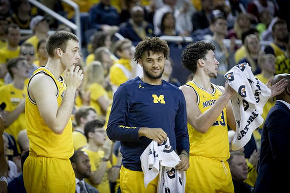 Austin Davis (51), Isaiah Livers (4), and Brandon Johns Jr. (23)