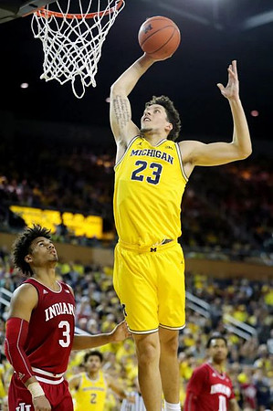 Brandon Johns Jr. (23) and Jordan Poole (2)