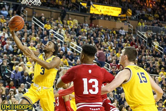 Zavier Simpson (3) and Jon Teske (15)