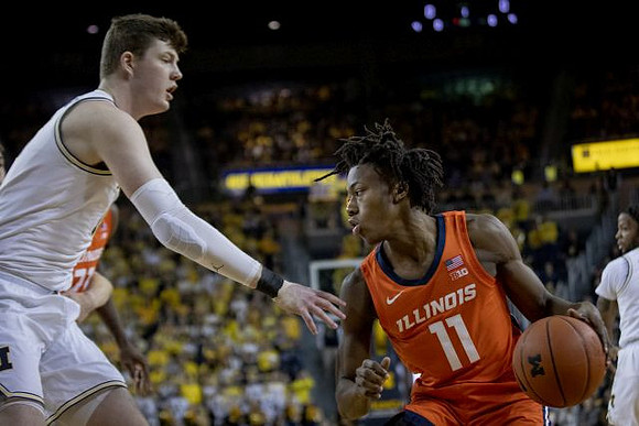 Jon Teske (15) and Zavier Simpson (3)