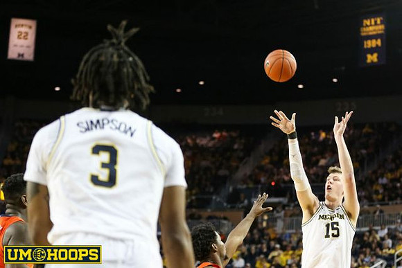 Zavier Simpson (3) and Jon Teske (15)