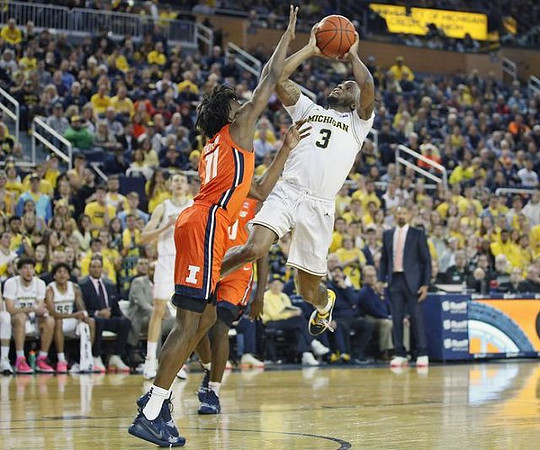 Zavier Simpson (3), Franz Wagner (21), and Juwan Howard