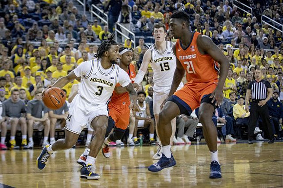 Zavier Simpson (3) and Jon Teske (15)