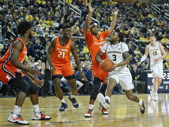 Zavier Simpson (3) and Jon Teske (15)