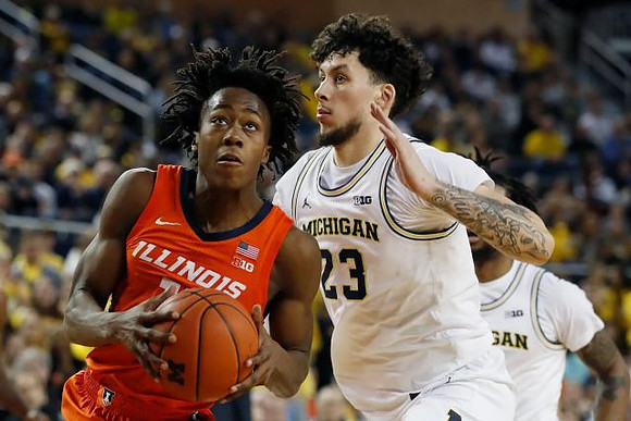 Brandon Johns Jr. (23) and Zavier Simpson (3)