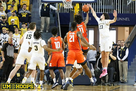 Jon Teske (15), Zavier Simpson (3), and Brandon Johns Jr. (23)