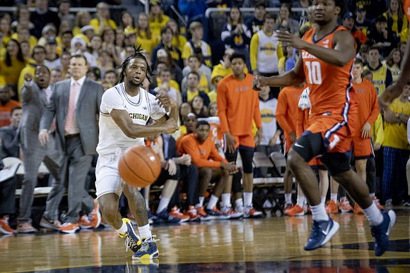 Zavier Simpson (3) and Illinois Head Coach Brad Underwood