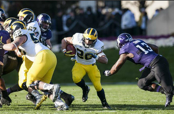 Mason Cole (52), Kyle Kalis (67), and Drake Johnson (20)