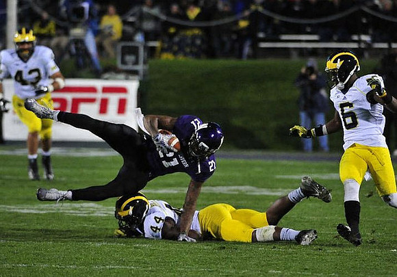 Chris Wormley (43), Delano Hill (44), and Raymon Taylor (6)